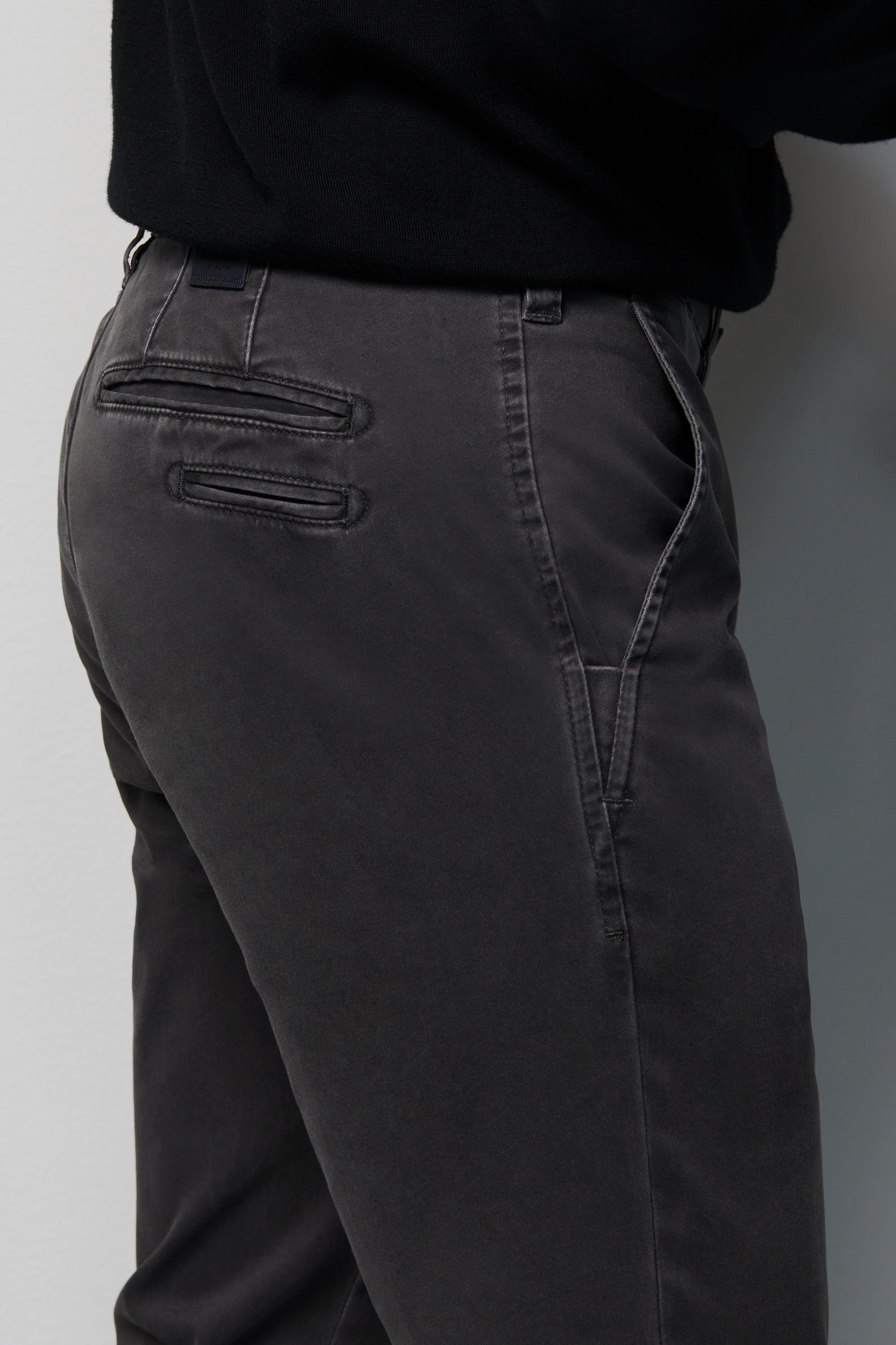 Dark gray pants with a plain background